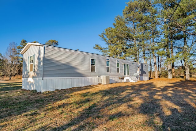 view of home's exterior featuring a yard and central AC unit