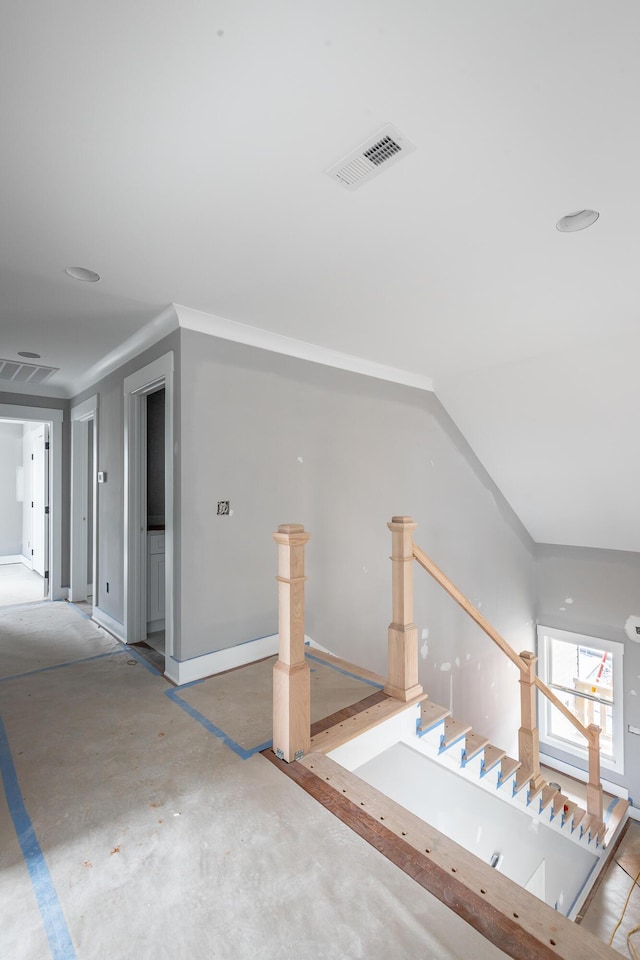 staircase featuring concrete flooring