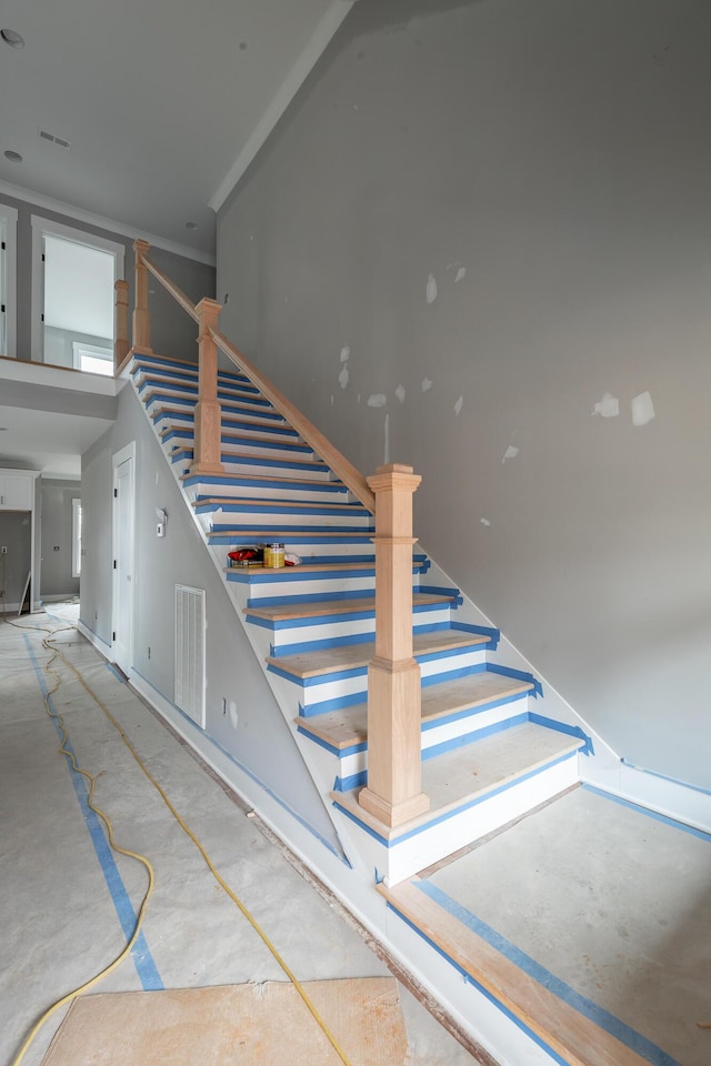 staircase with ornamental molding