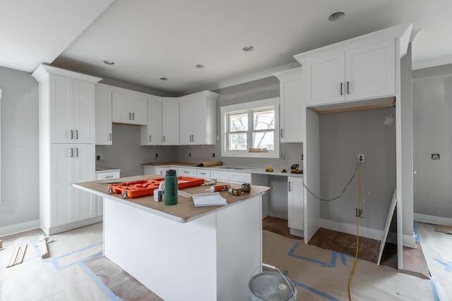 kitchen with a center island, light hardwood / wood-style floors, and white cabinets