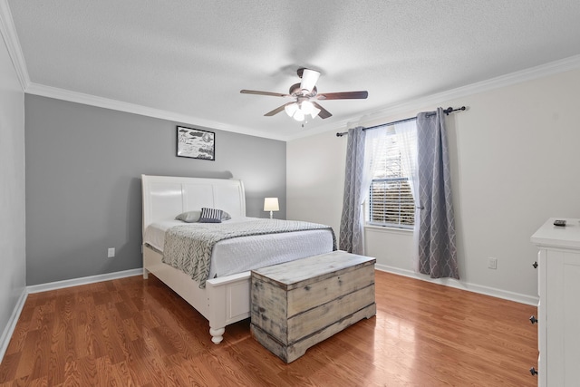 bedroom with dark hardwood / wood-style flooring, ornamental molding, a textured ceiling, and ceiling fan