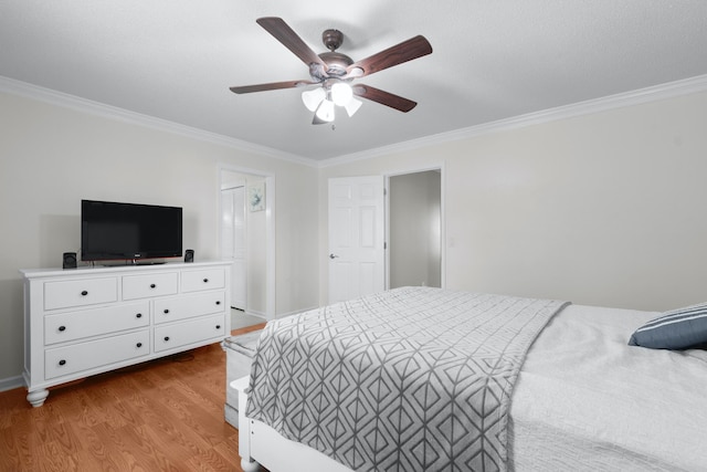 bedroom featuring ceiling fan, ornamental molding, and light hardwood / wood-style floors