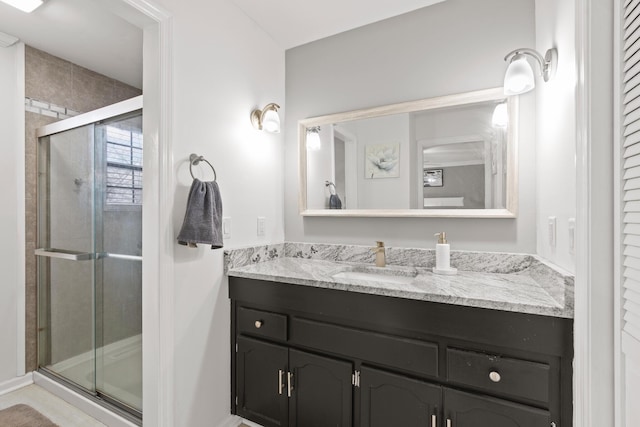 bathroom with vanity and a shower with shower door