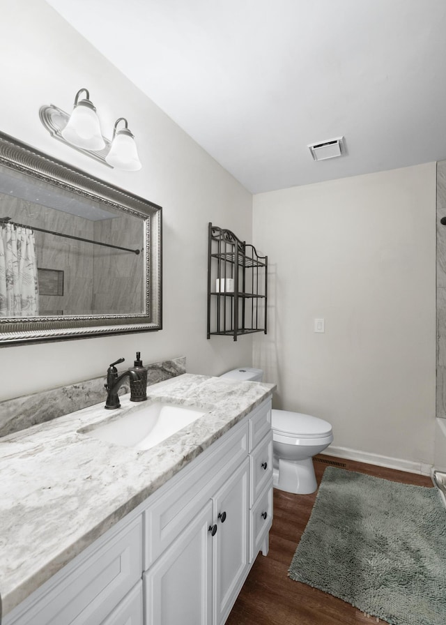 bathroom featuring vanity, toilet, and hardwood / wood-style floors