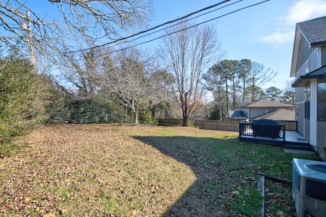 view of yard featuring a wooden deck and central AC unit