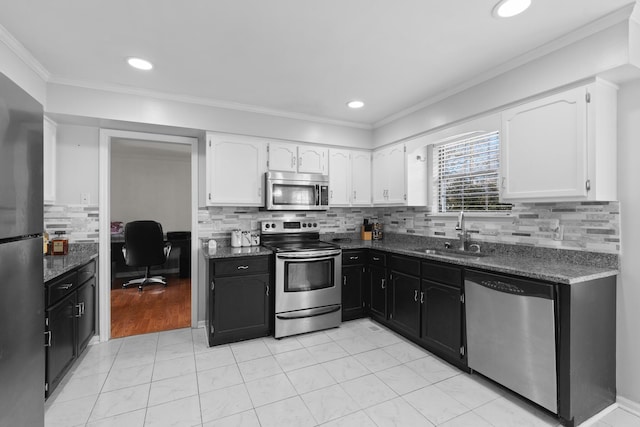 kitchen with stainless steel appliances, white cabinetry, sink, and crown molding