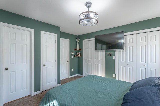 carpeted bedroom with multiple closets