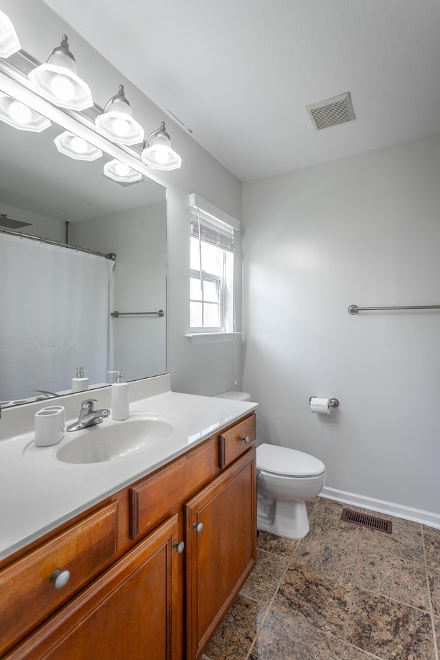 bathroom featuring vanity and toilet