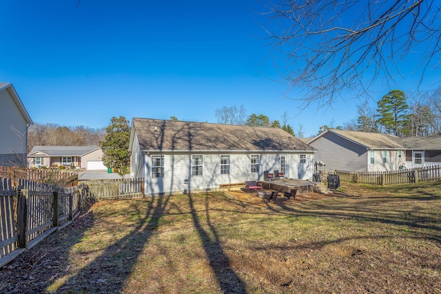 back of property with a yard and a deck