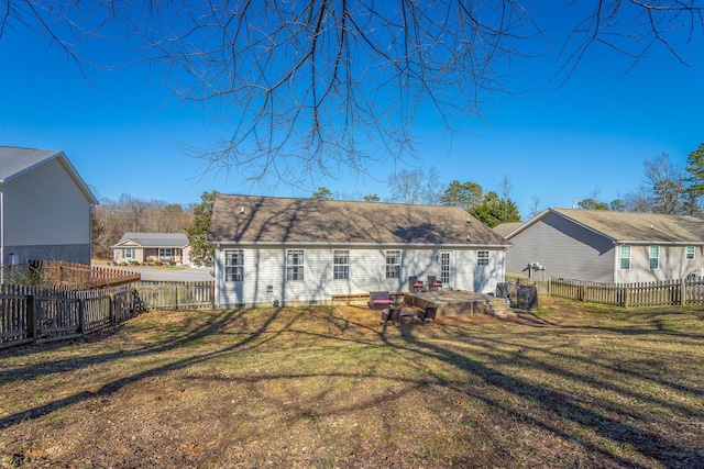 rear view of house with a lawn and a patio