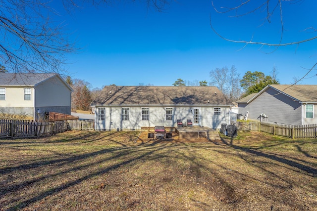 rear view of house featuring a yard