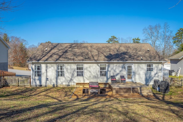 rear view of property featuring a deck and a lawn