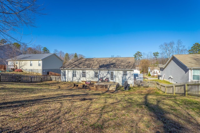 rear view of property with a lawn and a patio