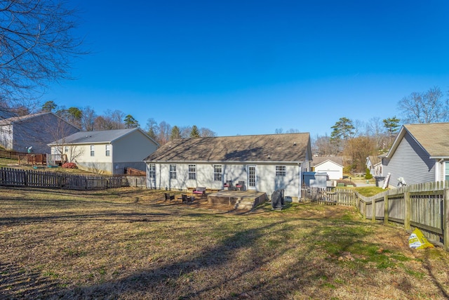 rear view of property with a yard