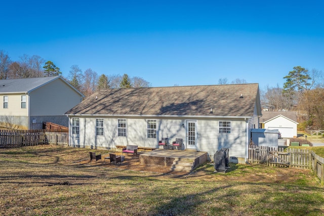 rear view of house featuring a yard and a deck