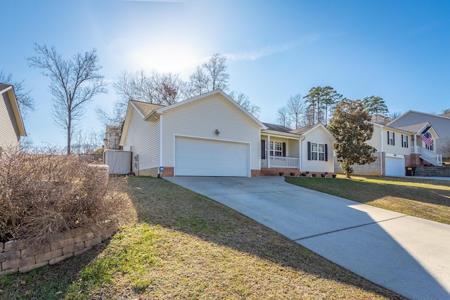 view of front of home with a garage, covered porch, and a front lawn