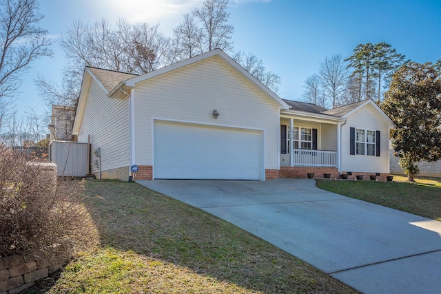 single story home with a porch, a garage, and a front yard