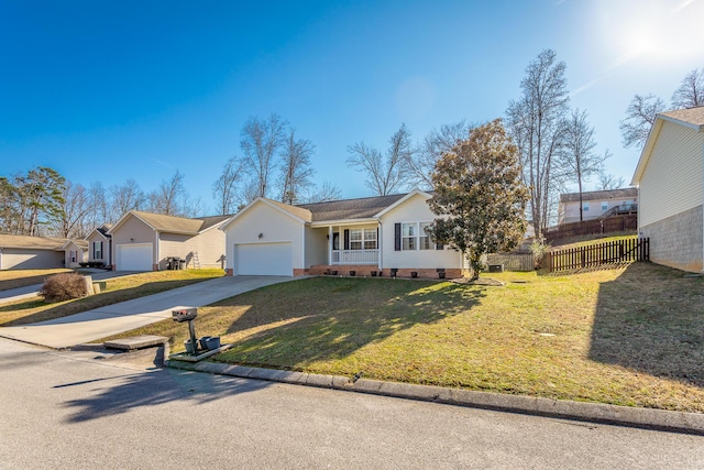 ranch-style home featuring a garage and a front lawn