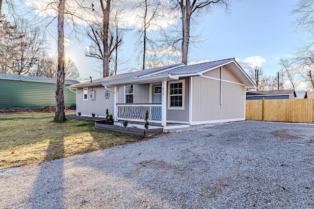 ranch-style house with a front lawn and a porch