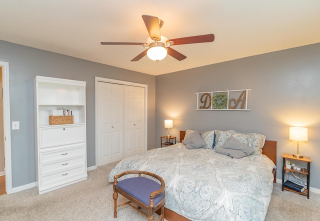 carpeted bedroom with ceiling fan and a closet