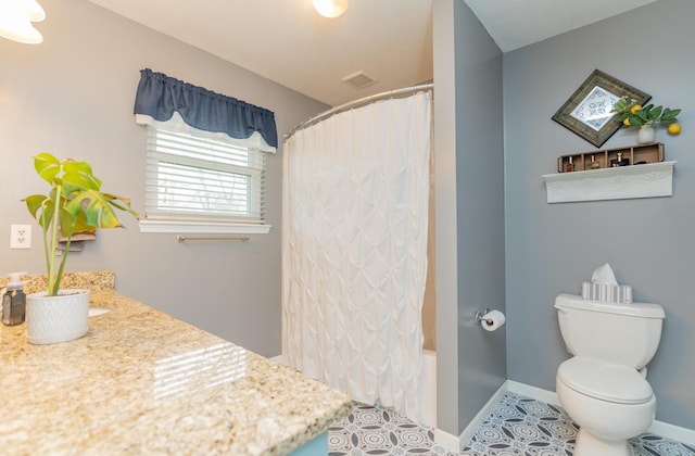 full bathroom featuring vanity, toilet, tile patterned flooring, and shower / bath combo with shower curtain