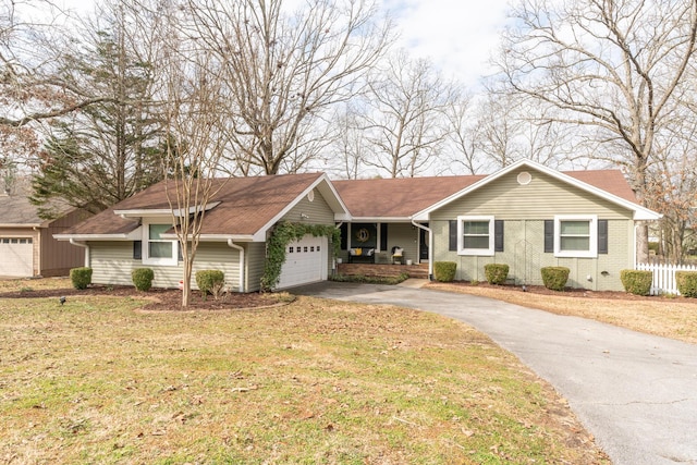 single story home with a garage and a front lawn