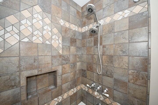 bathroom featuring a fireplace and tiled shower