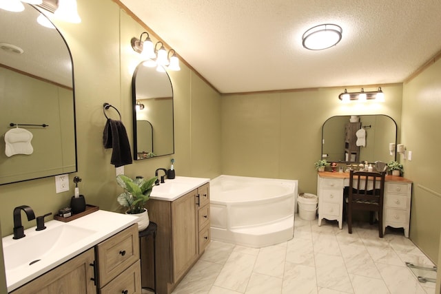 bathroom featuring crown molding, vanity, a textured ceiling, and a tub