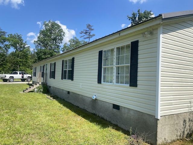 view of home's exterior with a yard