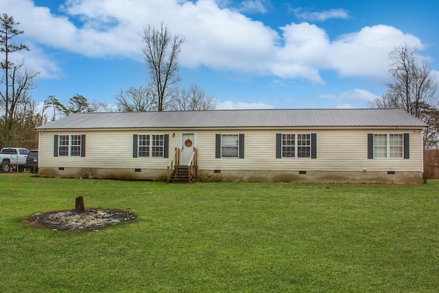 view of front of home with a front yard, metal roof, and crawl space