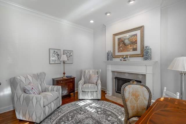 living area featuring dark hardwood / wood-style flooring, crown molding, and a tile fireplace