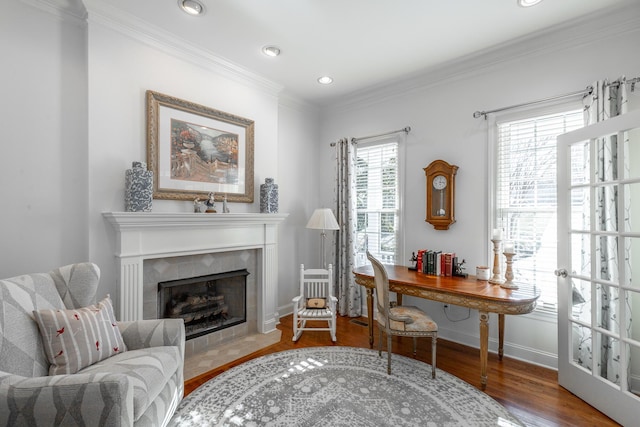 interior space with hardwood / wood-style flooring, crown molding, and a fireplace