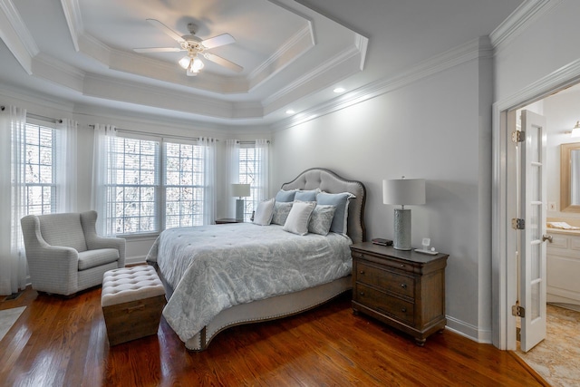 bedroom with crown molding, ceiling fan, dark hardwood / wood-style flooring, and a raised ceiling