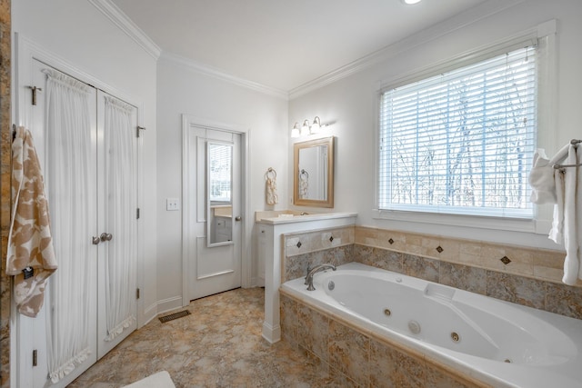 bathroom featuring crown molding, tiled tub, and a wealth of natural light