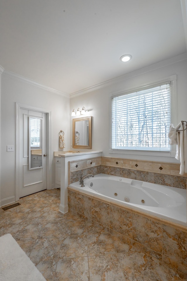 bathroom featuring ornamental molding and a relaxing tiled tub