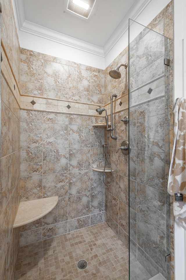 bathroom featuring crown molding and tiled shower