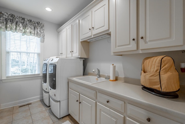 washroom with cabinets, independent washer and dryer, sink, and light tile patterned floors