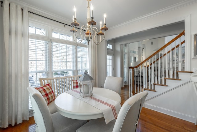 dining space with ornamental molding, dark hardwood / wood-style flooring, and a notable chandelier