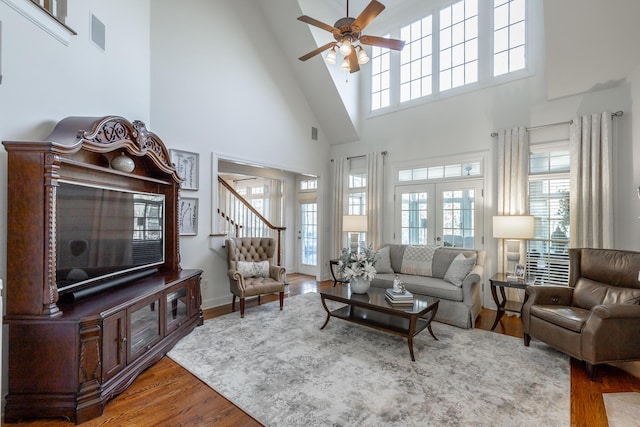 living room featuring hardwood / wood-style flooring, ceiling fan, and french doors