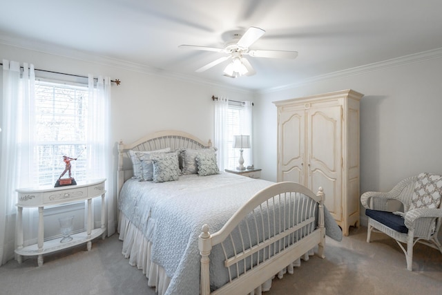 carpeted bedroom with ceiling fan and ornamental molding