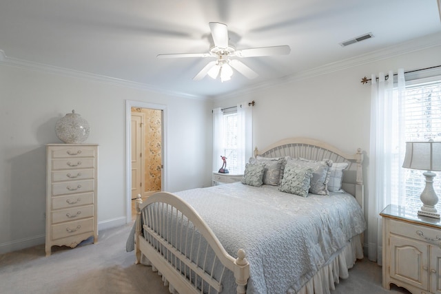 carpeted bedroom featuring multiple windows, ensuite bath, ornamental molding, and ceiling fan