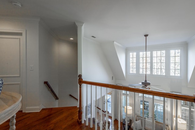 stairway with crown molding and hardwood / wood-style floors