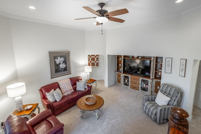 carpeted living room with crown molding and ceiling fan