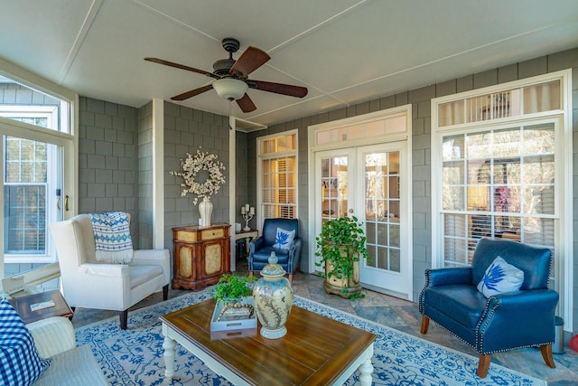 sunroom / solarium featuring french doors and ceiling fan