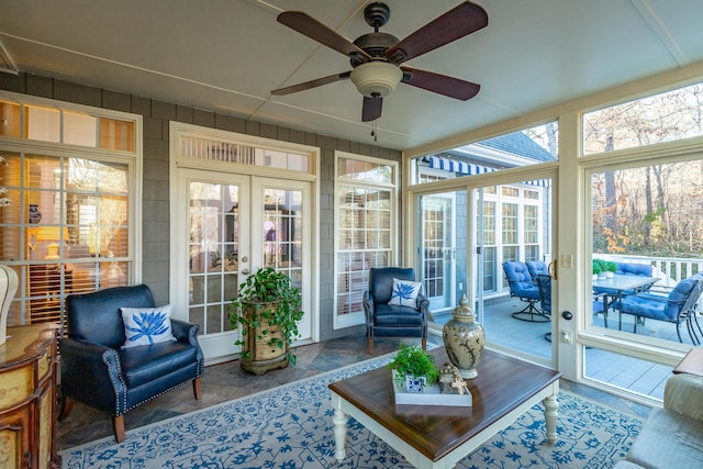 sunroom featuring plenty of natural light, ceiling fan, and french doors