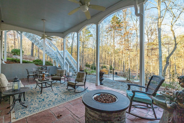 sunroom / solarium featuring ceiling fan