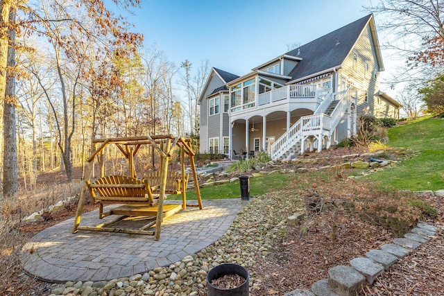 back of property with a patio, a sunroom, and a wooden deck