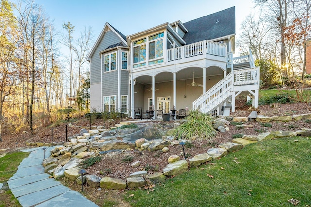 back of house with a wooden deck, ceiling fan, and a patio area