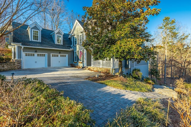 view of property hidden behind natural elements featuring a garage