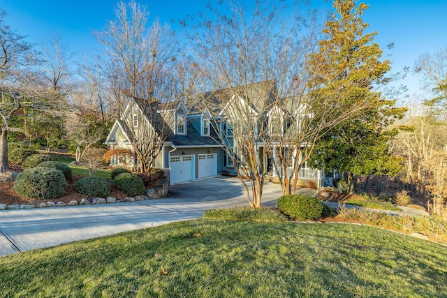 view of front of house with a garage and a front lawn